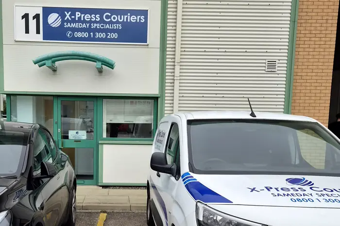 The X-Press Couriers depot entrance at Unit 11 Park Court, with a liveried van parked outside
