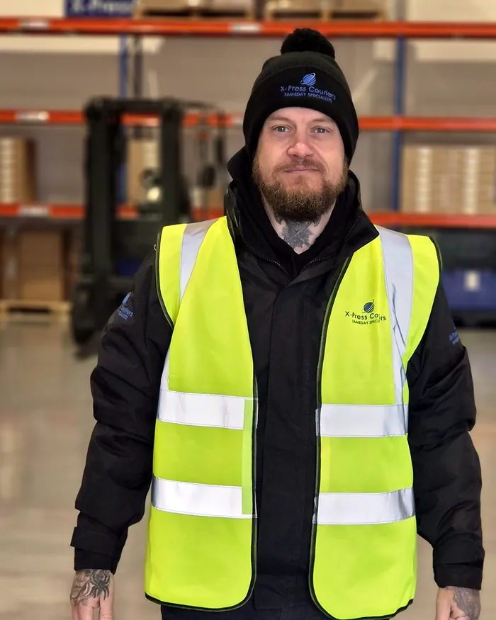 Neil Marshall, director of X-Press Couriers, in company hi-vis at the St Helens warehouse