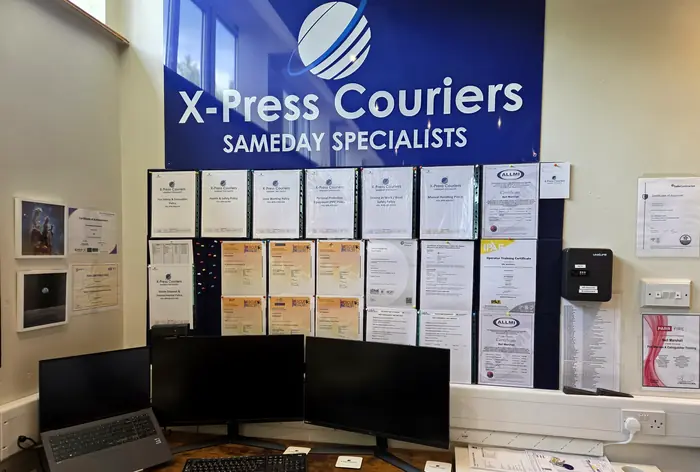 The X-Press Couriers office with company branding and certificates on the wall